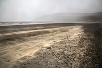 A streak of white sand on a mostly black volcanic sand beach in Glen Brittle, Isle of Skye.