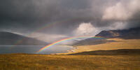 A double rainbow arches between Loch Brittle and Sgùrr nan Gobhar on the Isle of Skye.